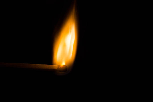 istock Match bursting into flame against a black background 592652142