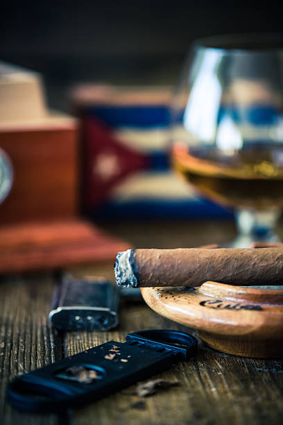 istock smoking cuban cigar and humidor in background 592653158