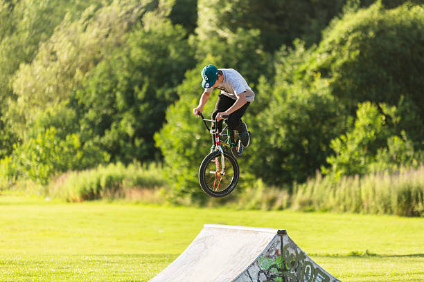 BMX rider jumping obstacle in Skate Park stock photo