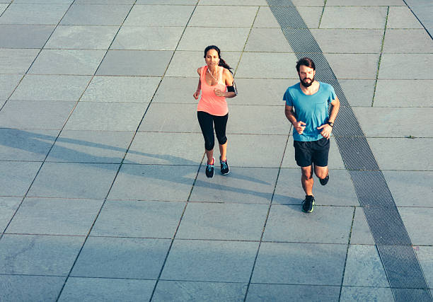 istock Young female and male running 592654536