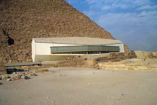 Giza Plateu, Egypt - November 08, 2008: View of the Solar Boat museum next to the Great Pyramid of Cheops of Khufu.