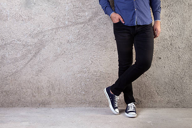 istock Young man standing on a concrete floor 592657356