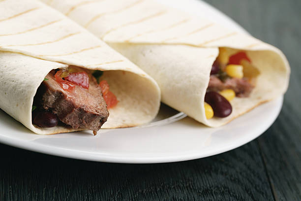 istock burritos with beef steak, corn, black beans and salsa 592657854