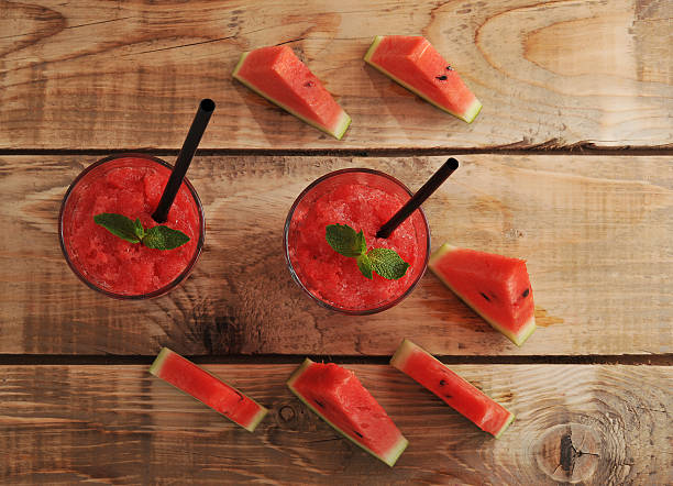 istock two glasses of watermelon smoothie with straws 592658480