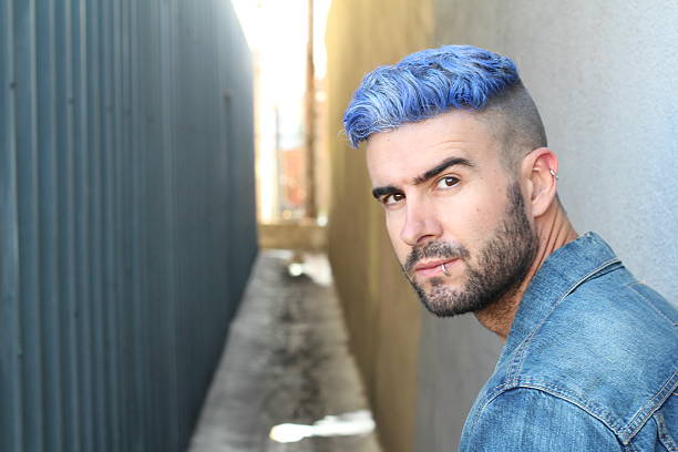 istock Man with blue dyed hair undercut hairstyle 592659402
