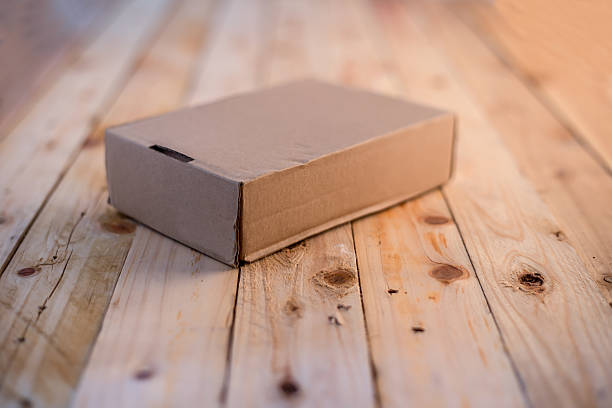 istock blank cardboard on wooden floor 592659634
