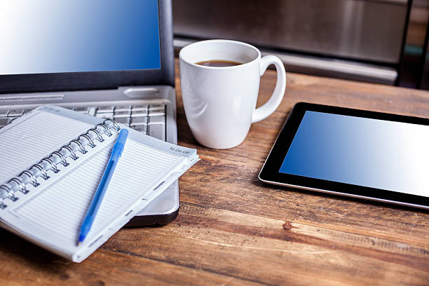 istock Laptop, digital tablet technology on desk with notepad and coffee. 592659650