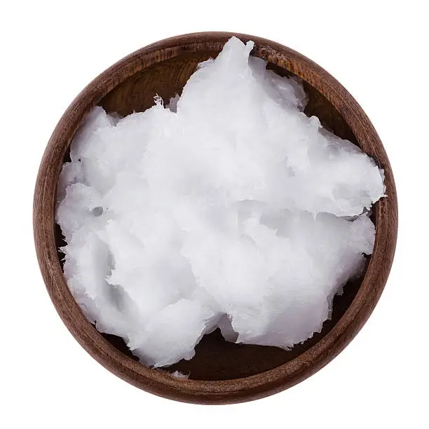 Photo of Coconut oil in a bowl on white background