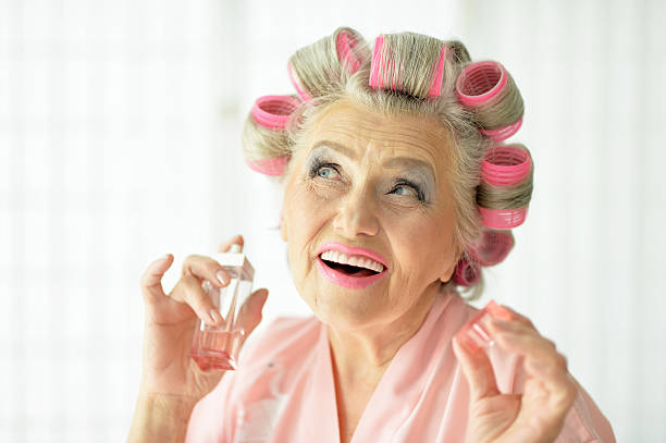 istock Senior woman in  hair rollers 592661610