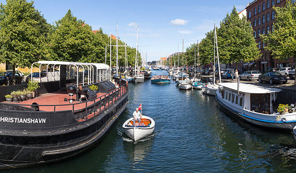 Copenhagen, Denmark - August 17, 2016: Tourist boats and sailboats in Christianshavn channel on a summer day