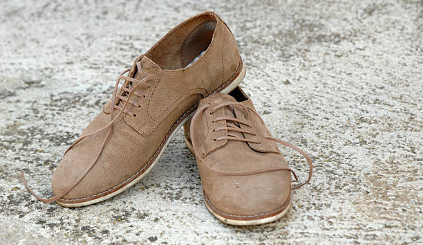 istock Male shoes on cement background 592662644