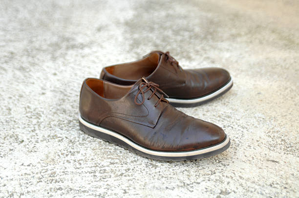 istock Male shoes on cement background 592662728