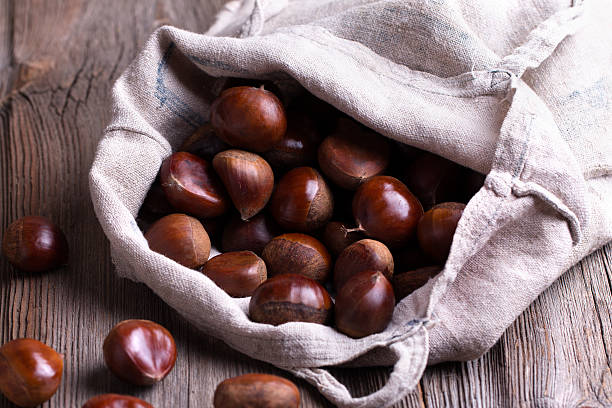 istock chestnuts on the old wooden table 592663754