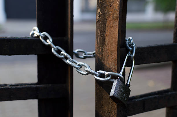 istock Chain and lock on the iron fence. Closeup view. Sharp 592667994