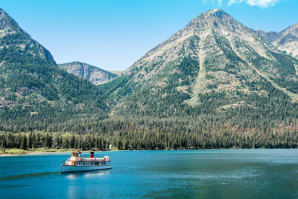 istock Waterton Tour Boat with Glacier National Park mountain background 592668314
