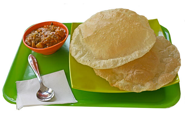 istock Indian Breakfast  - fresh hot puri (poori) with vegetable curry 592668986
