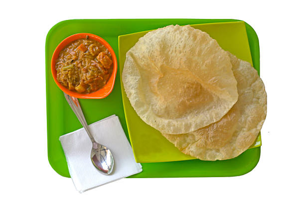 istock Indian Breakfast  - fresh hot puri (poori) with vegetable curry 592668990