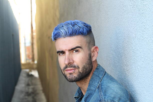 istock Blue haired guy walk on old rusty alley 592669060
