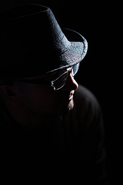 istock man in glasses reading looking at phone sitting on couch 592669302