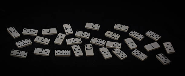 istock Dominoes isolated on a black background 592670038