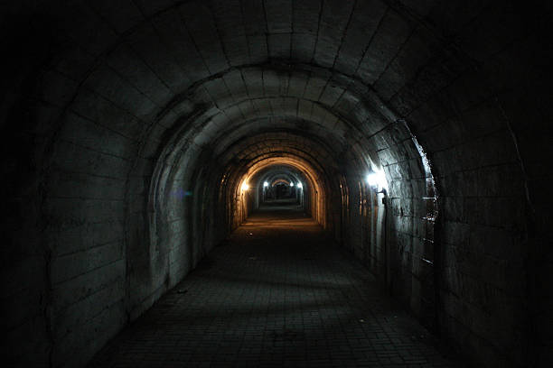 istock Mysterious dungeon- tunnel with walls made of stone 592670542