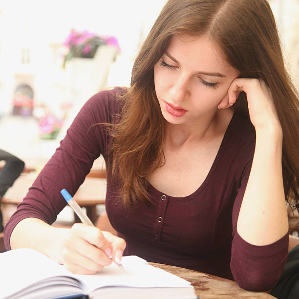 istock young beautiful girl is preparing for exam 592671368