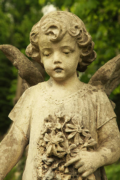istock Vintage image of a sad angel on a cemetery 592672440