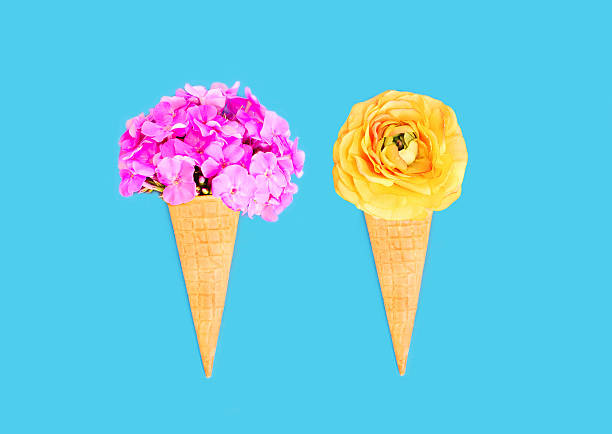 istock Two ice cream cone with flowers over blue colorful background 592672526