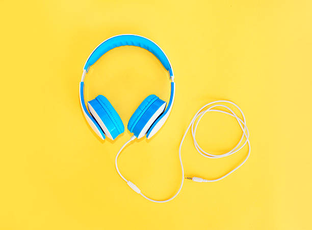 istock Blue headphones lie on a colorful yellow background 592673040
