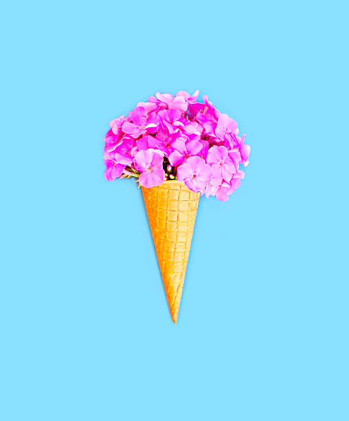 istock Ice cream cone with flowers over blue background top view 592673264