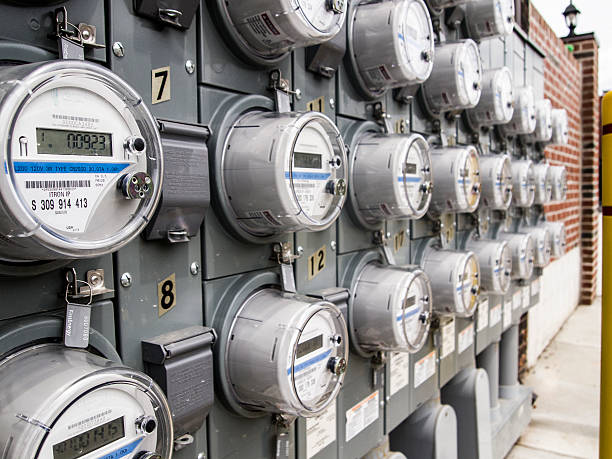 Panel of electric meters York, Pennsylvania, USA - July 26, 2016: Panel of Met-ed Energy First electric meters along the brick wall of an office building in downtown York Pennsylvania amperage stock pictures, royalty-free photos & images