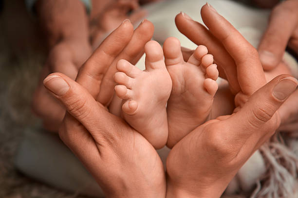 istock Mother tenderly holding her babys feet 592674348