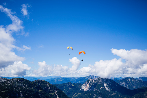 rocky mountain landscape with flying parachute, Austria