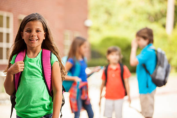 istock Elementary-age children, girl on school campus. 592675888
