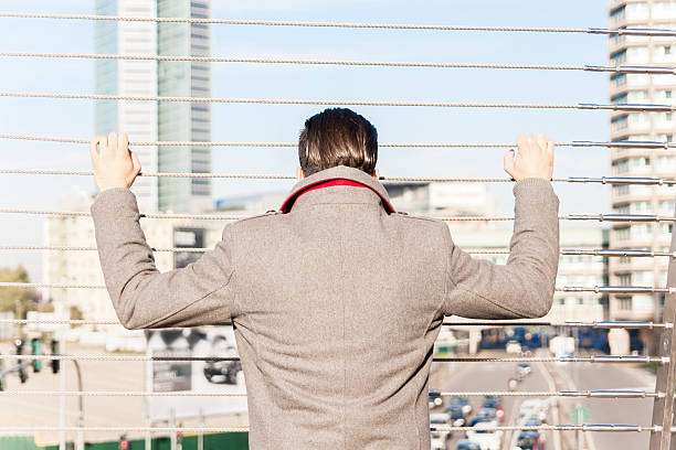 istock young hipster look at traffic on an iron bridge 592677218