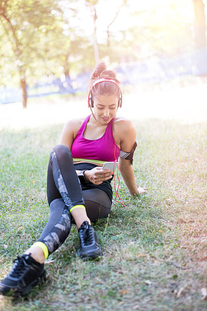 istock Happy young woman resting after running 592678426
