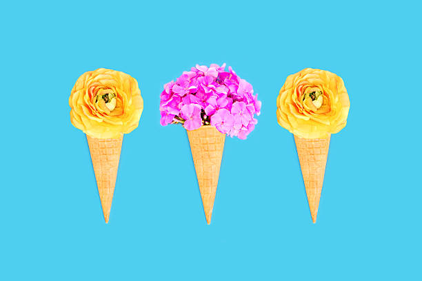 istock Three ice cream cone with flowers over blue colorful background 592679820
