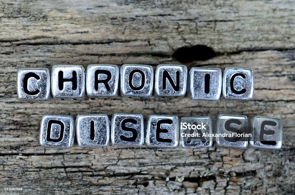 cube word chronic disease on table silver cube word chronic disease on wooden table Chronic Illness Stock Photo