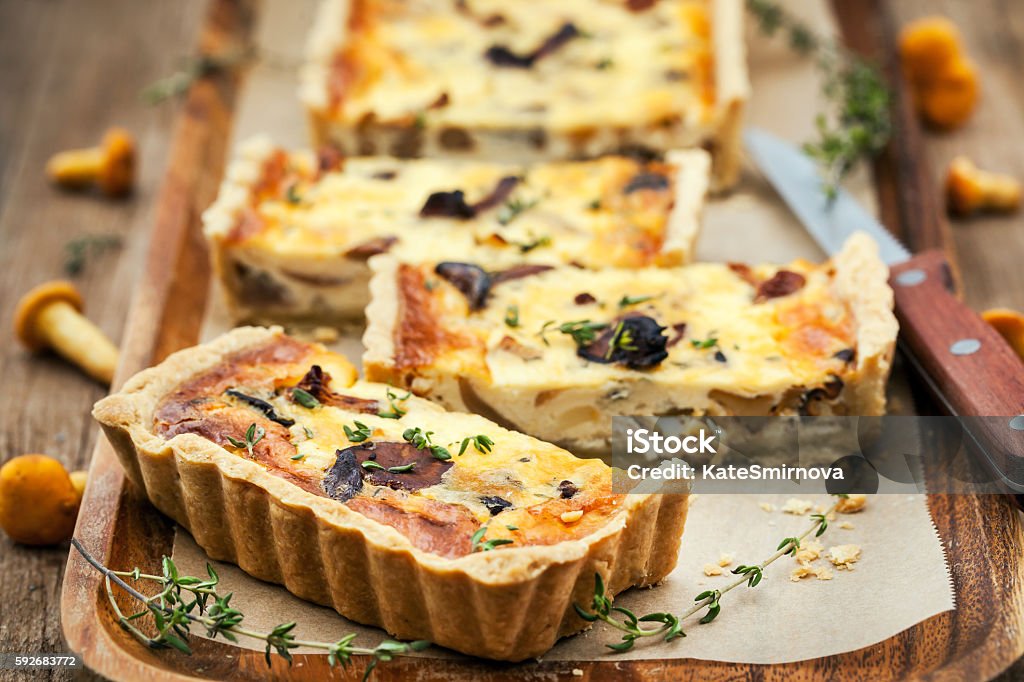 Chanterelle mushroom, cheese and thyme quiche Chanterelle mushroom, cheese and thyme homemade delicious tart (quiche) French Food Stock Photo