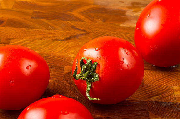 istock tomatoes on wooden background 592685394