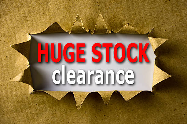 istock Torn brown paper with HUGE STOCK CLEARANCE words 592688800