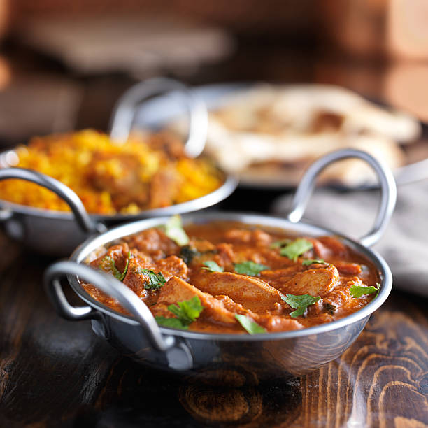 istock table with indian food and chicken curry in balti dishes 592689792