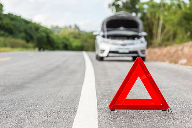 istock Red emergency stop sign and broken silver car 593295684