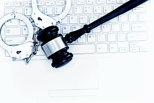istock Gavel and handcuffs on laptop keyboard 593297556