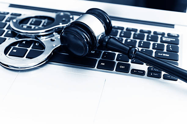 istock Gavel and handcuffs on laptop keyboard 593297652