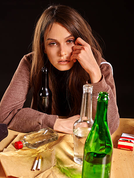 istock Girl in depression drinking alcohol. 593298094