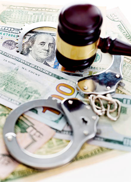 istock Judges gavel and handcuffs on american dollars 593298120