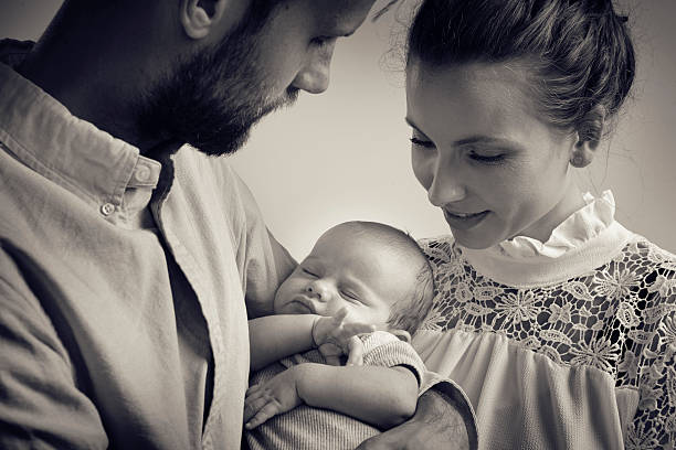 istock Proud parents are watching their newborn son 593300598