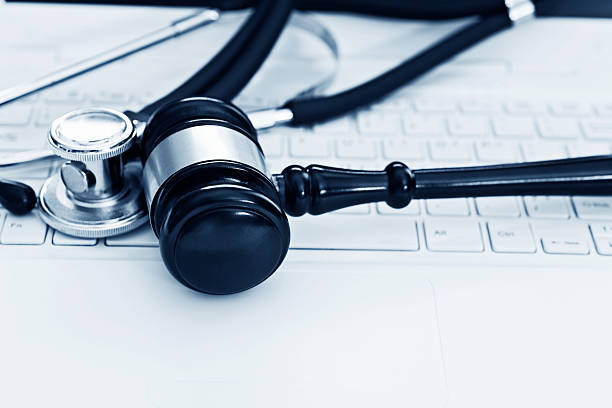istock Stethoscope and gavel on keyboard of laptop 593301142