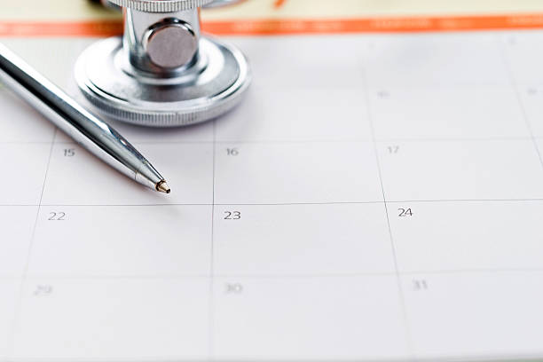istock Stethoscope and pen on calendar 593303220